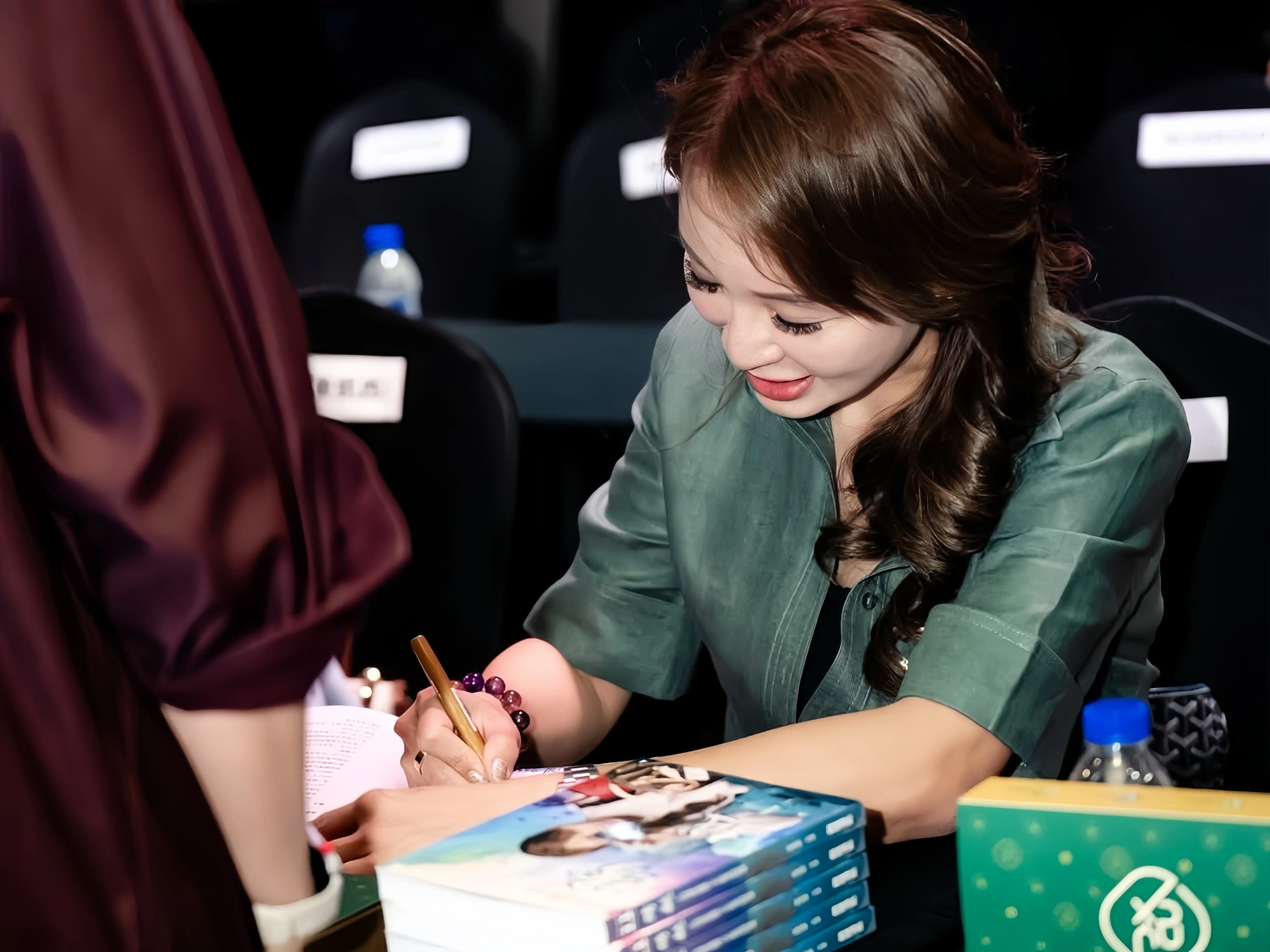 Samantha Loh signing copies of her book after a public talk on authentication, trust and industry standards.
